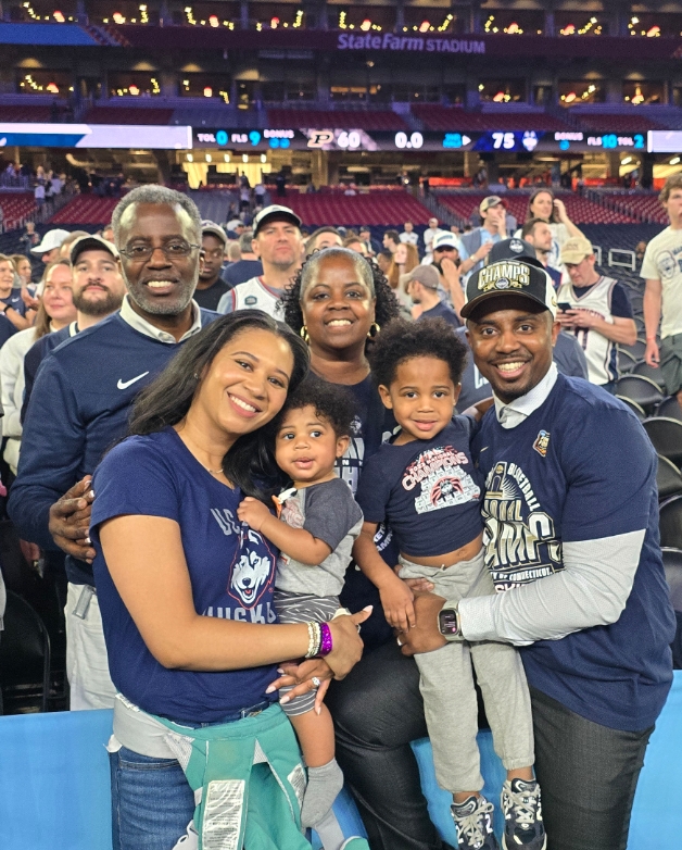Coach Herman Johnson Jr. with his family at the UConn national championship